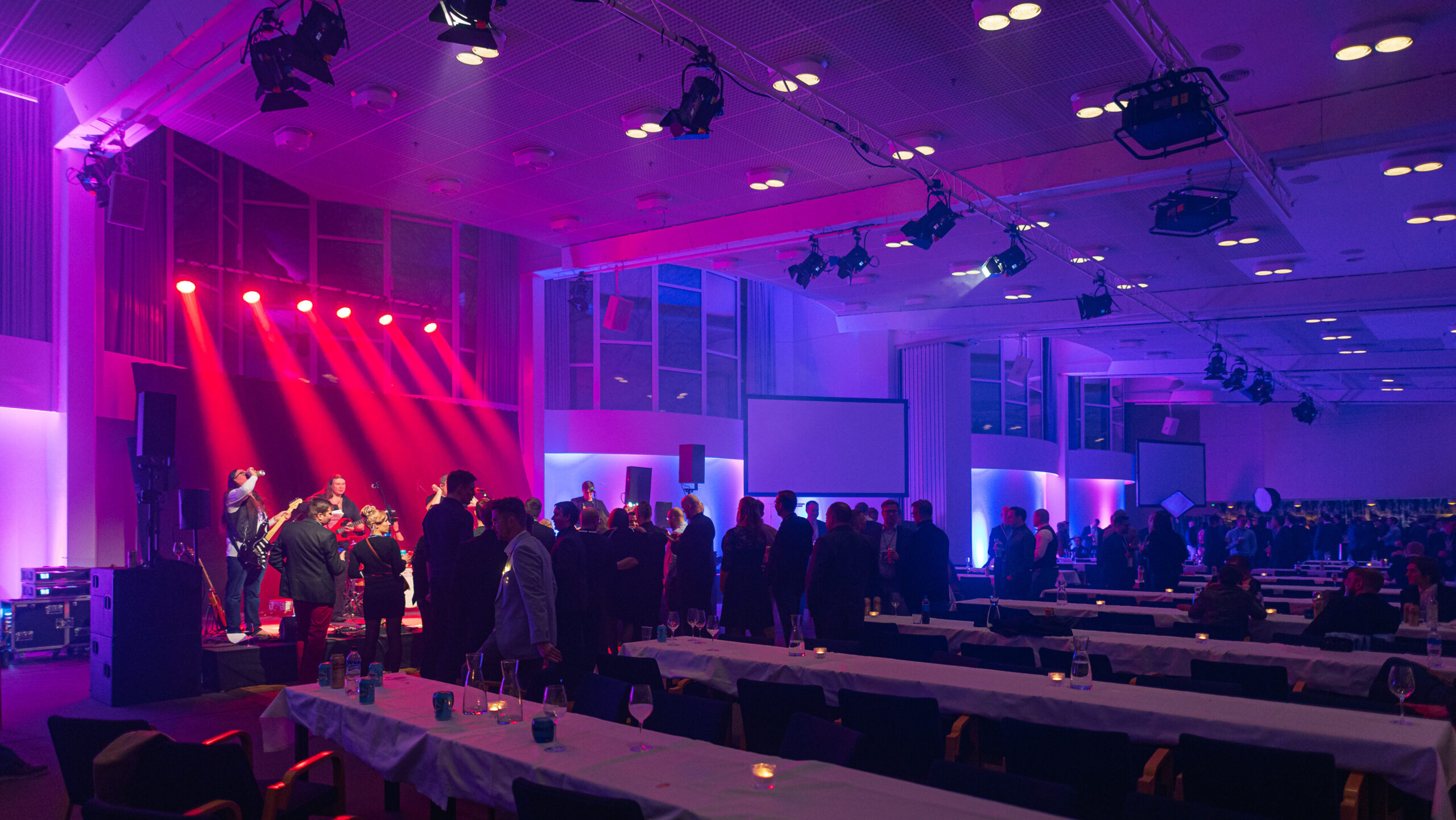 Happy people enjoying the evening and dancing to the live band after a 3 course dinner at a gala